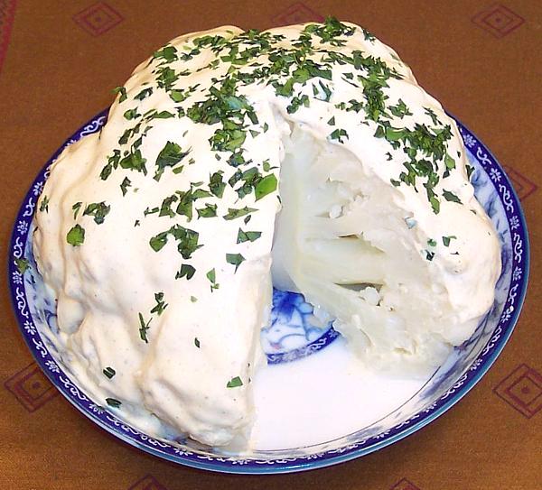 Dish holding Whole Cauliflower with Mayo Sauce