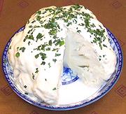 Dish holding Whole Cauliflower with Mayo Sauce