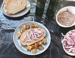 A plate with Surströmming on Bread, with Onions