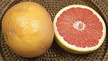 Whole and Cut Red Grapefruit